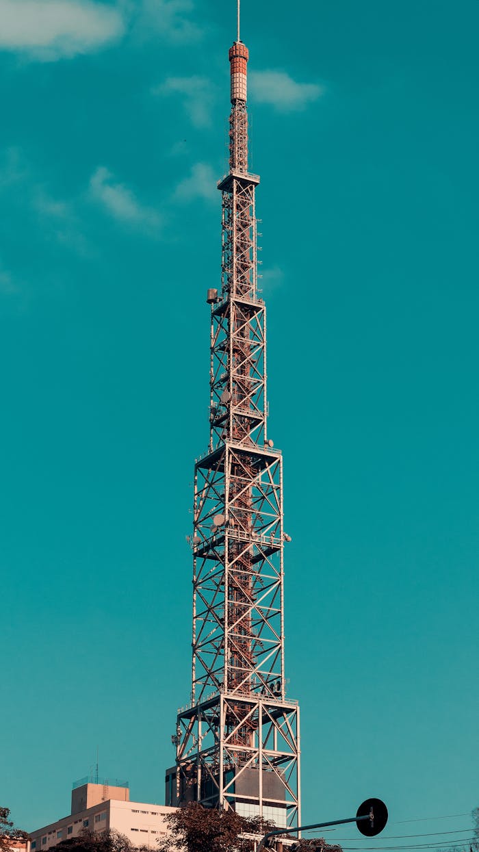 Broadcast tower in São Paulo, Brazil, reaching into a clear blue sky, symbolizing modern communication.